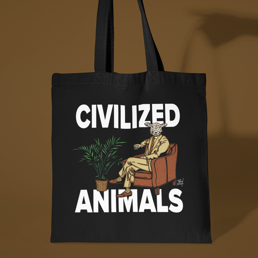Black tote bag with 'Civilized Animals' graphic design held by a hand against a brown background