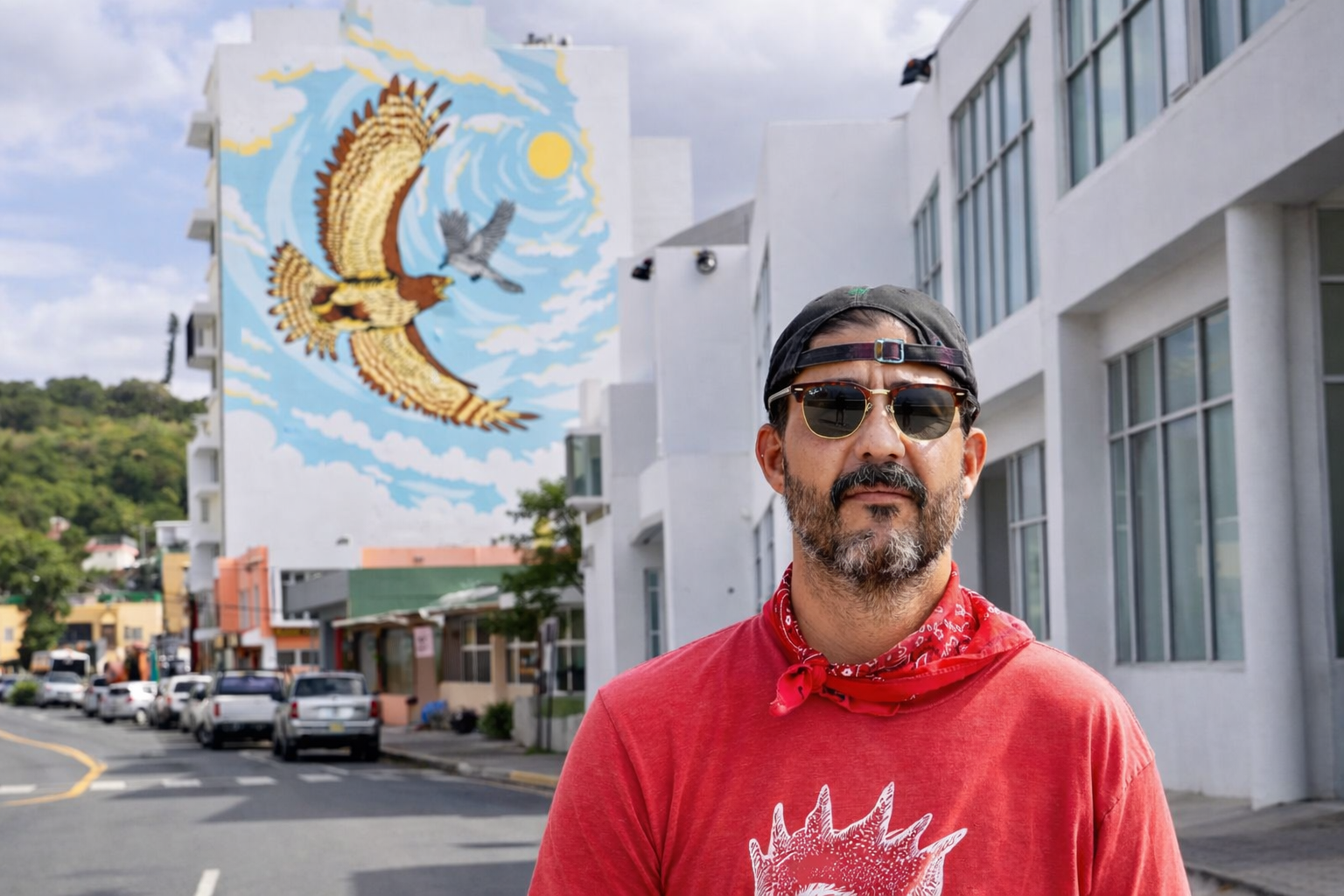 Padin Sosa posing in front of a large mural in Aguadilla Puerto Rico